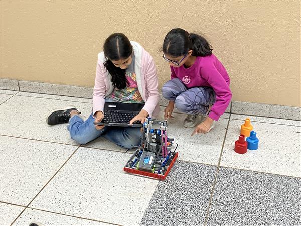 Students working on coding a robot.